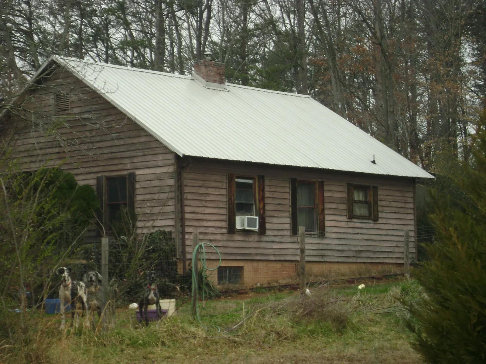 White metal roof on an old wood sided farmhouse, from a Metal Roof Installation job in Preston